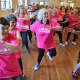 Hundreds Zumba in a packed auditorium at the Community Church of Ho-Ho-Kus for a "Dance for Danza" fundraiser.