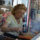Dolores Santucci works the hot dog stand at Karl Ehmer’s Quality Meats in downtown Hillsdale.