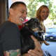 Guerrilla Fitness owner Joe Ghaznavi and Robyn Hendrix play with an adoptable dog.