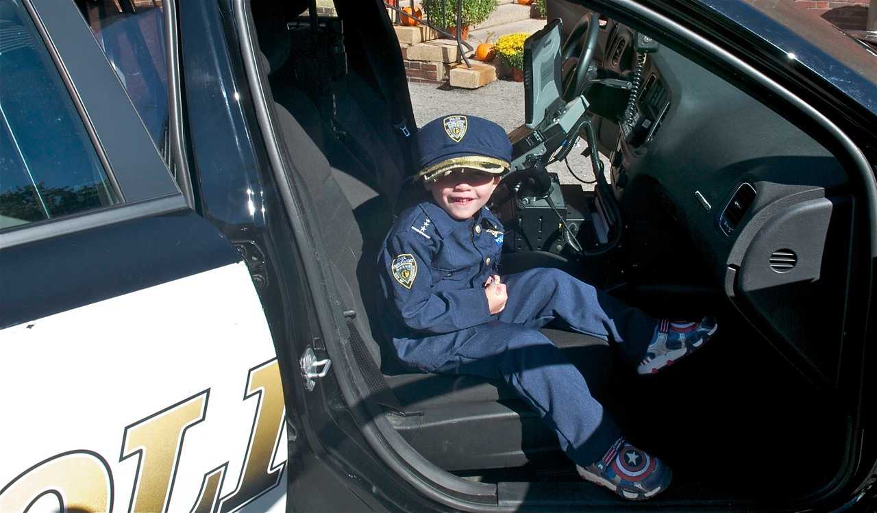 A boy who came dressed for the police open house.
