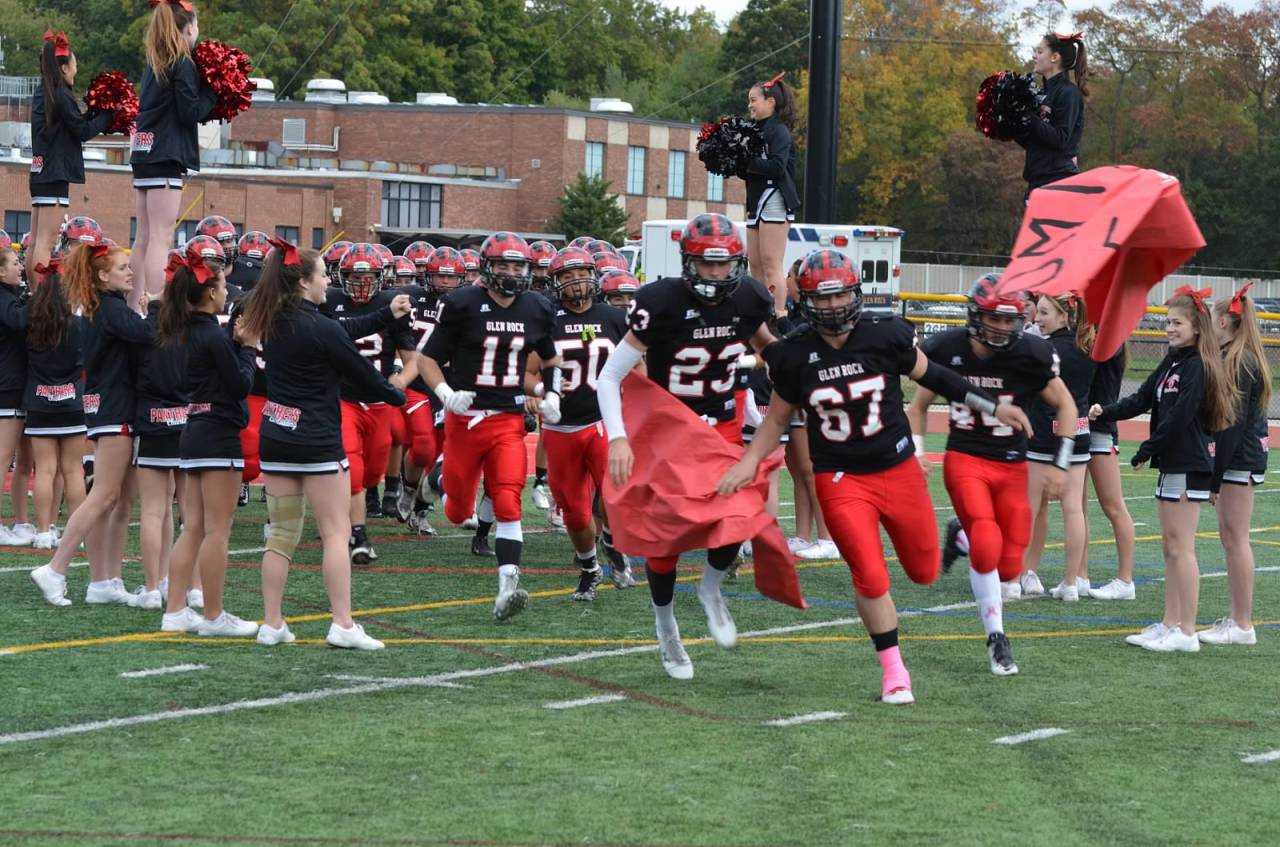 Glen Rock football players rush onto the field before playing Lyndhurst in October.