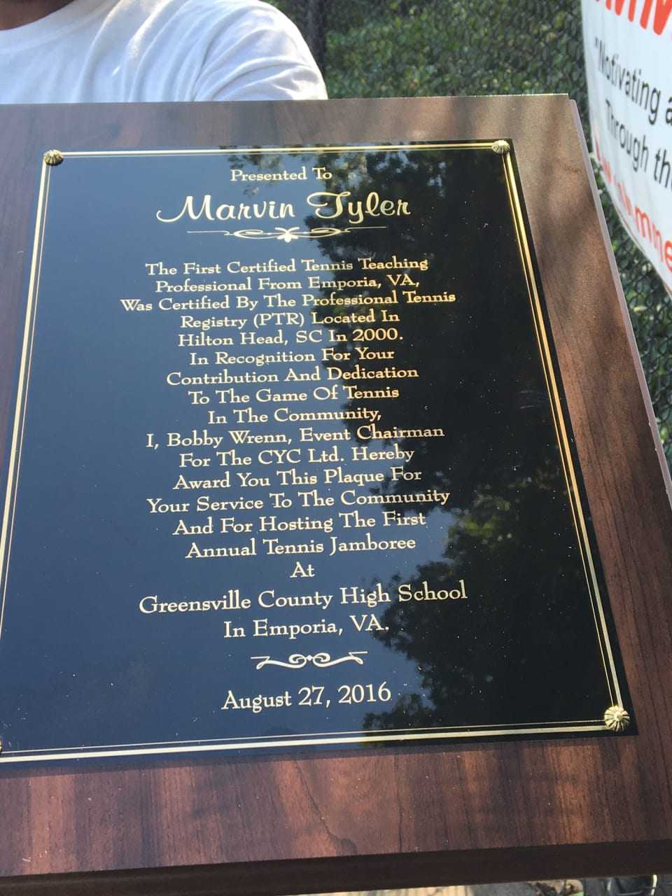 Marvin Tyler holds a plaque that he received from his hometown in Emporia, Va.
