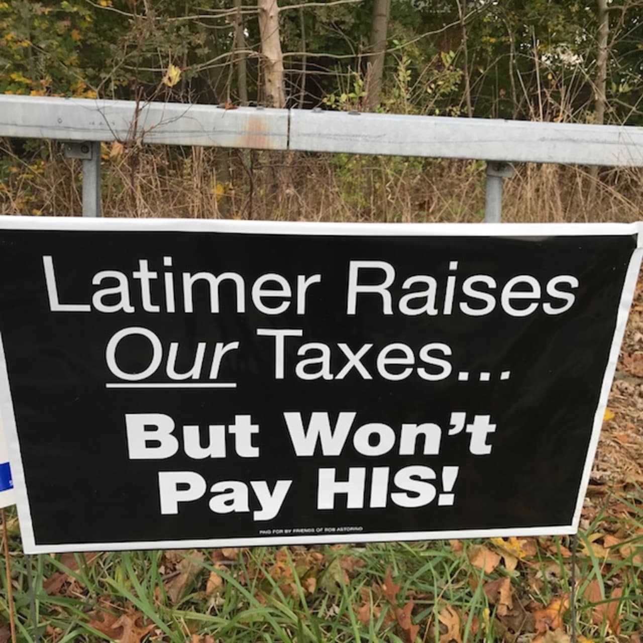 A closeup of new signs that popped up over the final weekend of state Sen. George Latimer's challenge to unseat Westchester County Executive Rob Astorino. The Latimer family owes more than $45,000 in taxes in Rye on  his late mother-in-law's estate.