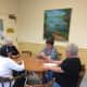 Friends play a hand of cards at the Trumbull Senior Center.
