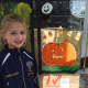 Katie McWilliams gets in the Halloween spirit with Ho-Ho-Kus UnPlugged's window painting event.