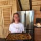 Darien's Jane Peters-Mossa holds a platters of dumplings at her 'farm-to-table' camp in Norwalk Monday.