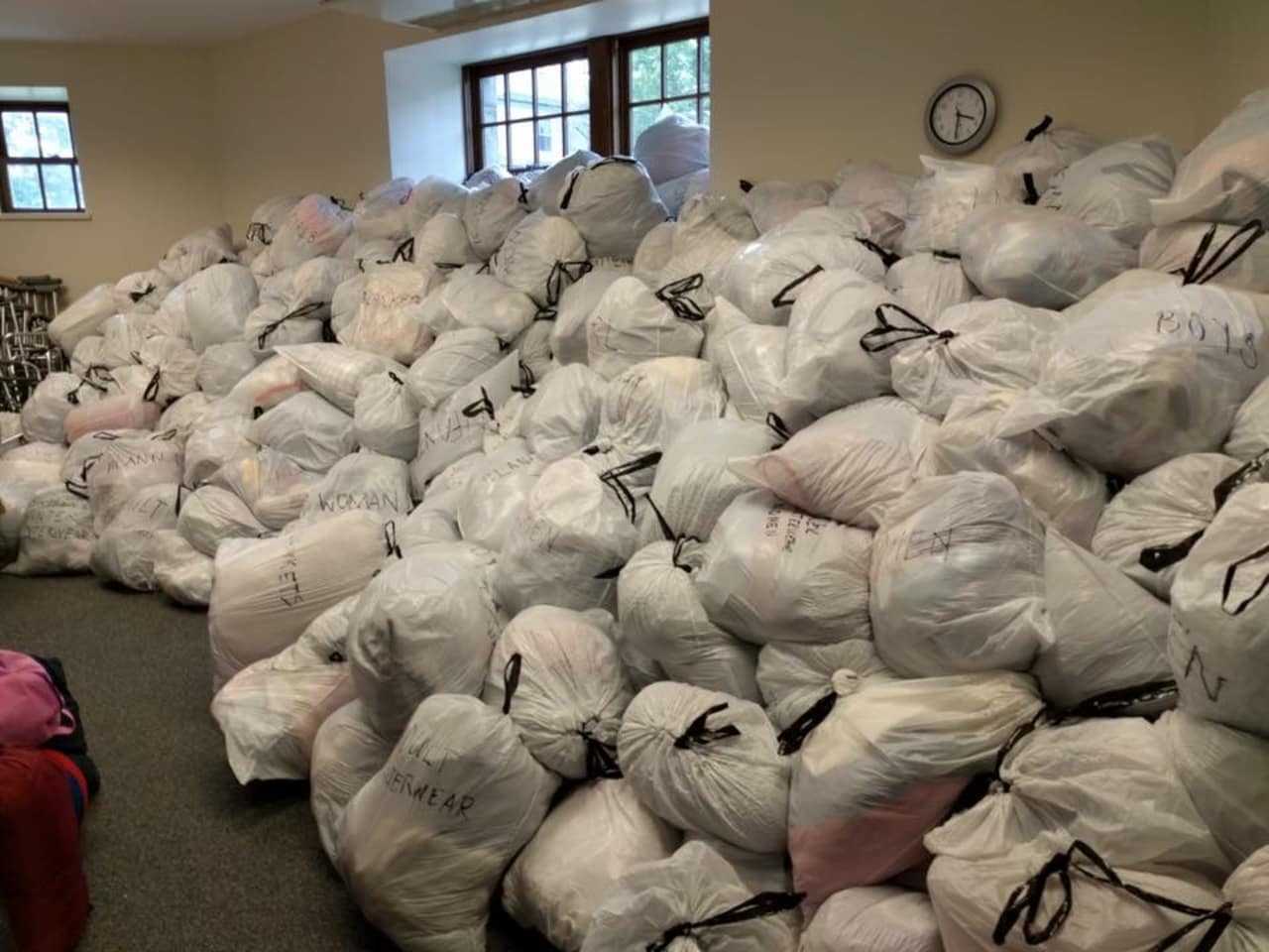 Piles of donated goods placed into bags as part of an effort to help Syrian refugees.