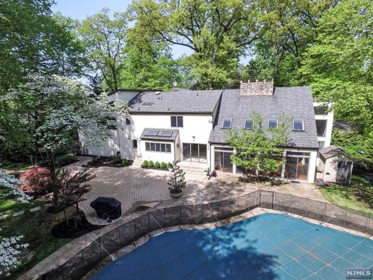 The backyard has a pool and playground.