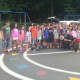 A Ramapo officer poses with Viola Elementary School students following his K-9 demonstration on Thursday.