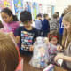 Students at East Elementary School, in New Canaan, packed items for Fill the Blanks bags, after having gathered food in a food drive.