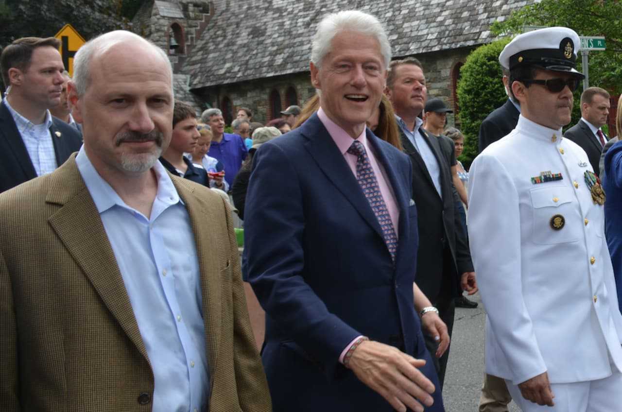 New Castle Supervisor Rob Greenstein (left), marches with former President Bill Clinton in the town of New Castle's annual Memorial Day parade, which went through downtown Chappaqua.