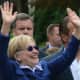 Hillary Clinton waves to onlookers as she marches in the town of New Castle's 2016 Memorial Day parade, which went through downtown Chappaqua.