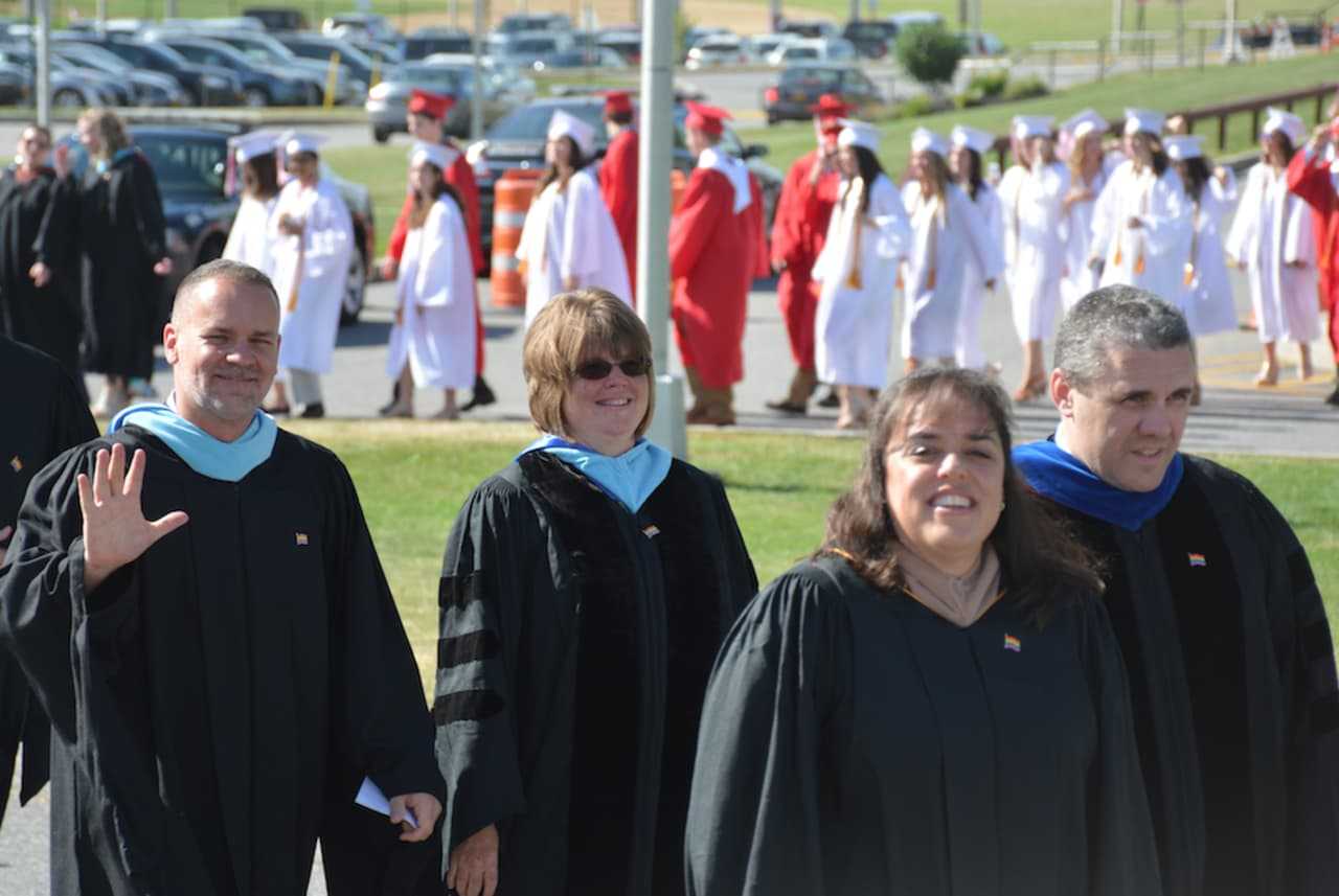 Somers school officials lead a long line of graduates to the 2016 commencement.