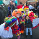 A child poses with clowns at the balloon inflation party Saturday for the UBS Parade Spectacular.