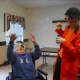 Spark Arts owner, Cynthia Rauschert, dressed as a clown, working with seniors.
