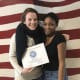 Regan Downey, a student at Sacred Heart University, stops to take a picture with her mentee during a mentoring session.