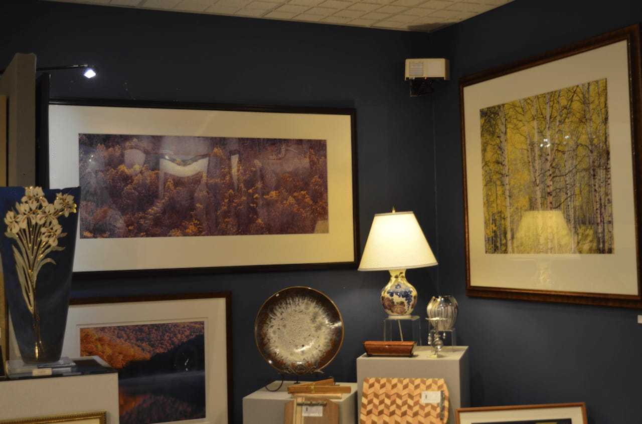 Framed art lines walls at Artists' Market, a haven for collectors and enthusiasts in Norwalk.