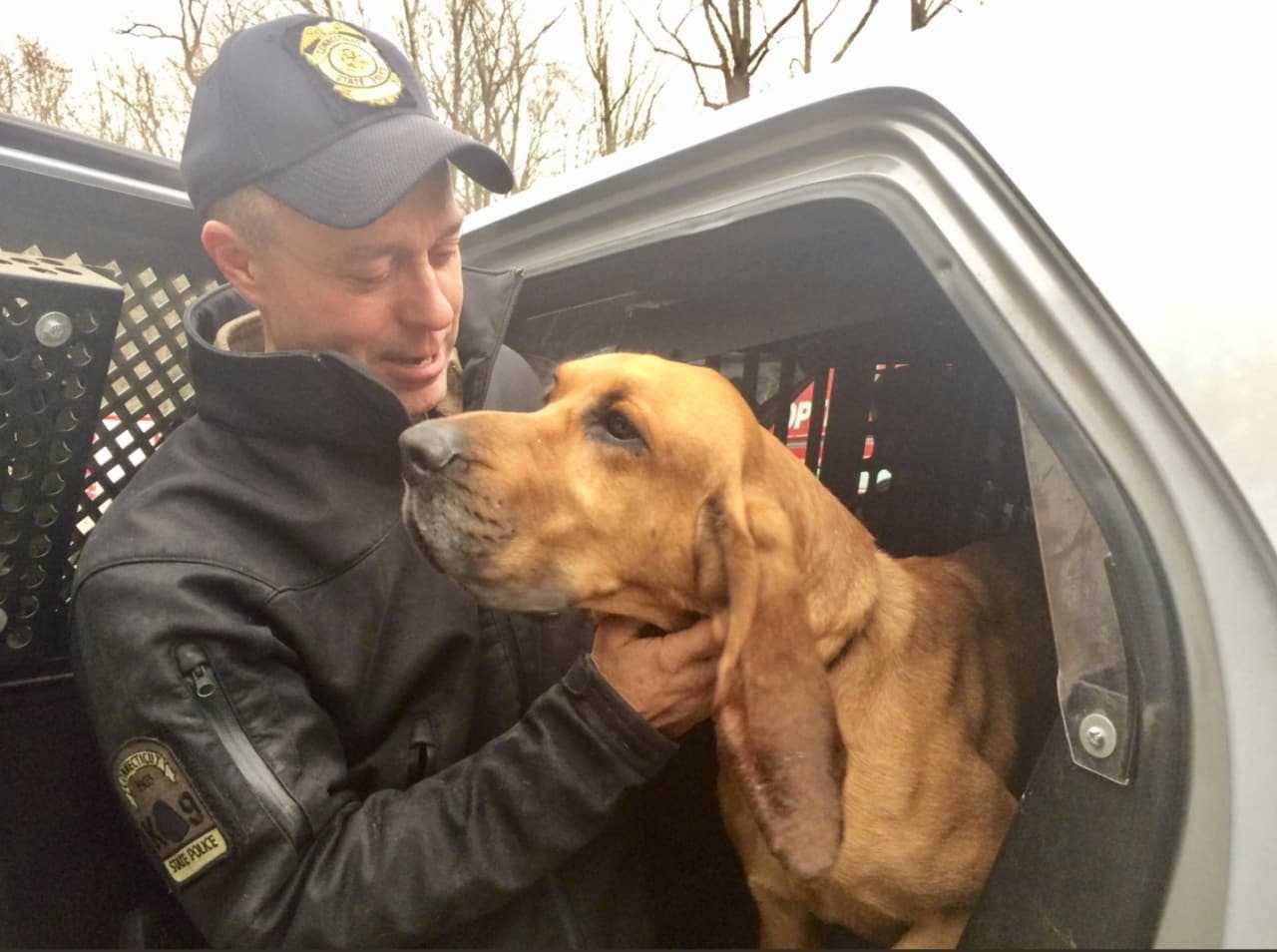 Trooper First Class Ed Anuszewski greets his K9 partner Texas, who was missing for 36 hours.