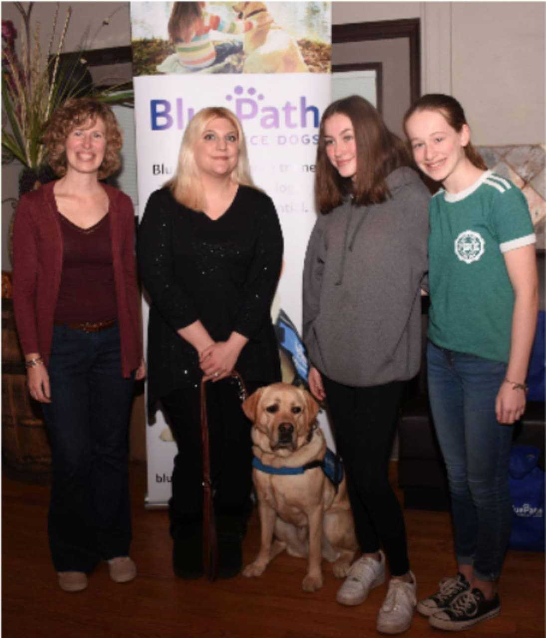 BluePath Service Dogs is looking for foster families to care for future autism service dogs (L-R) Jean Marie Trick, Jen Cavanagh (Sonny’s new mom), Trick’s daughters and BluePath Sonny