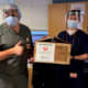 Hospital workers display face shields donated by Hatteras Printing of Tinton Falls.