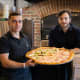 Hadi Parhizkaran (left) and Michael Ghinelli are opening Pizza Club in Garfield Wednesday, just seven months after opening their first location in Edgewater.