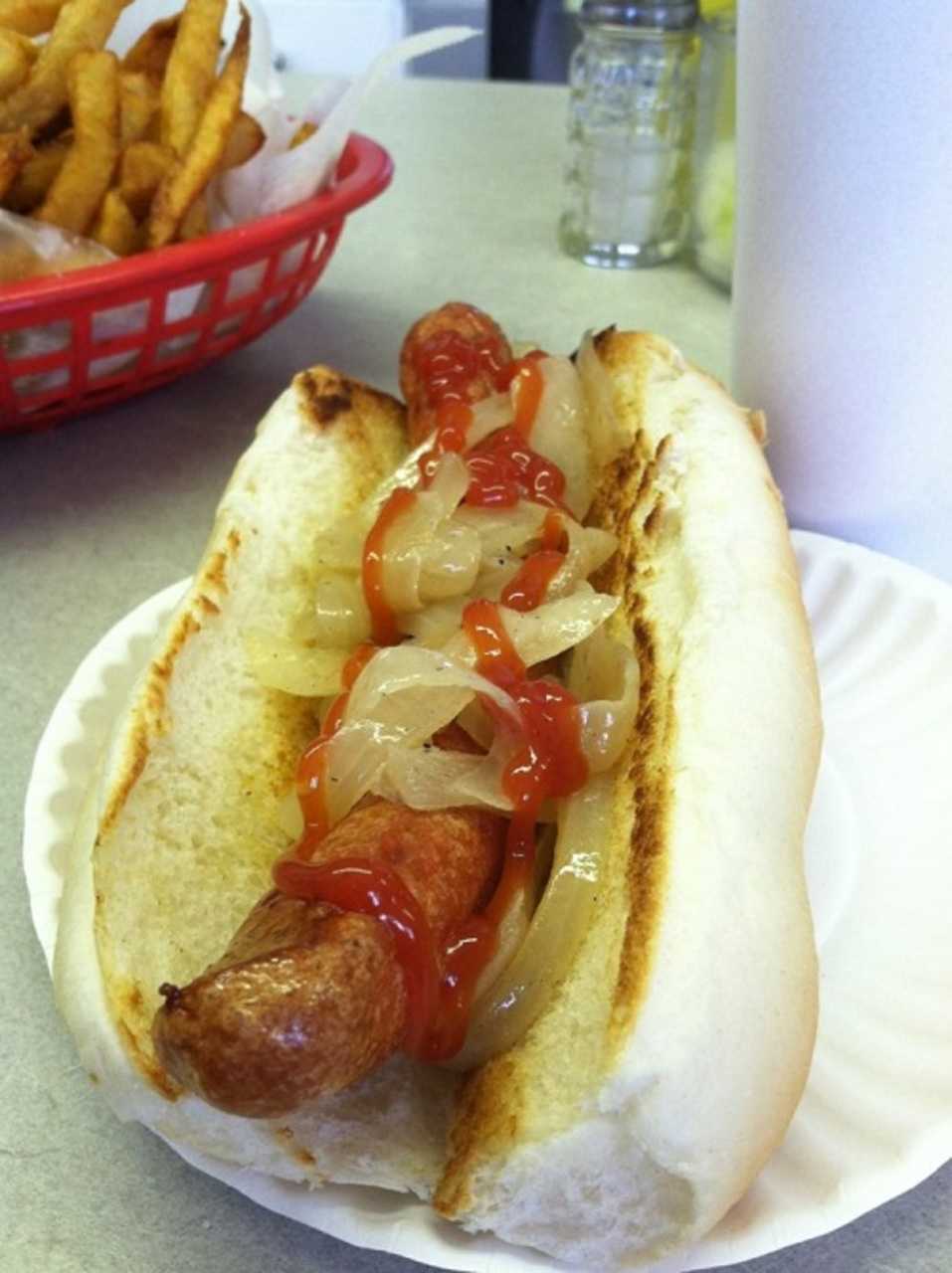 Grilled onions and ketchup top a fried dog at The Original Swanky Franks in Norwalk.