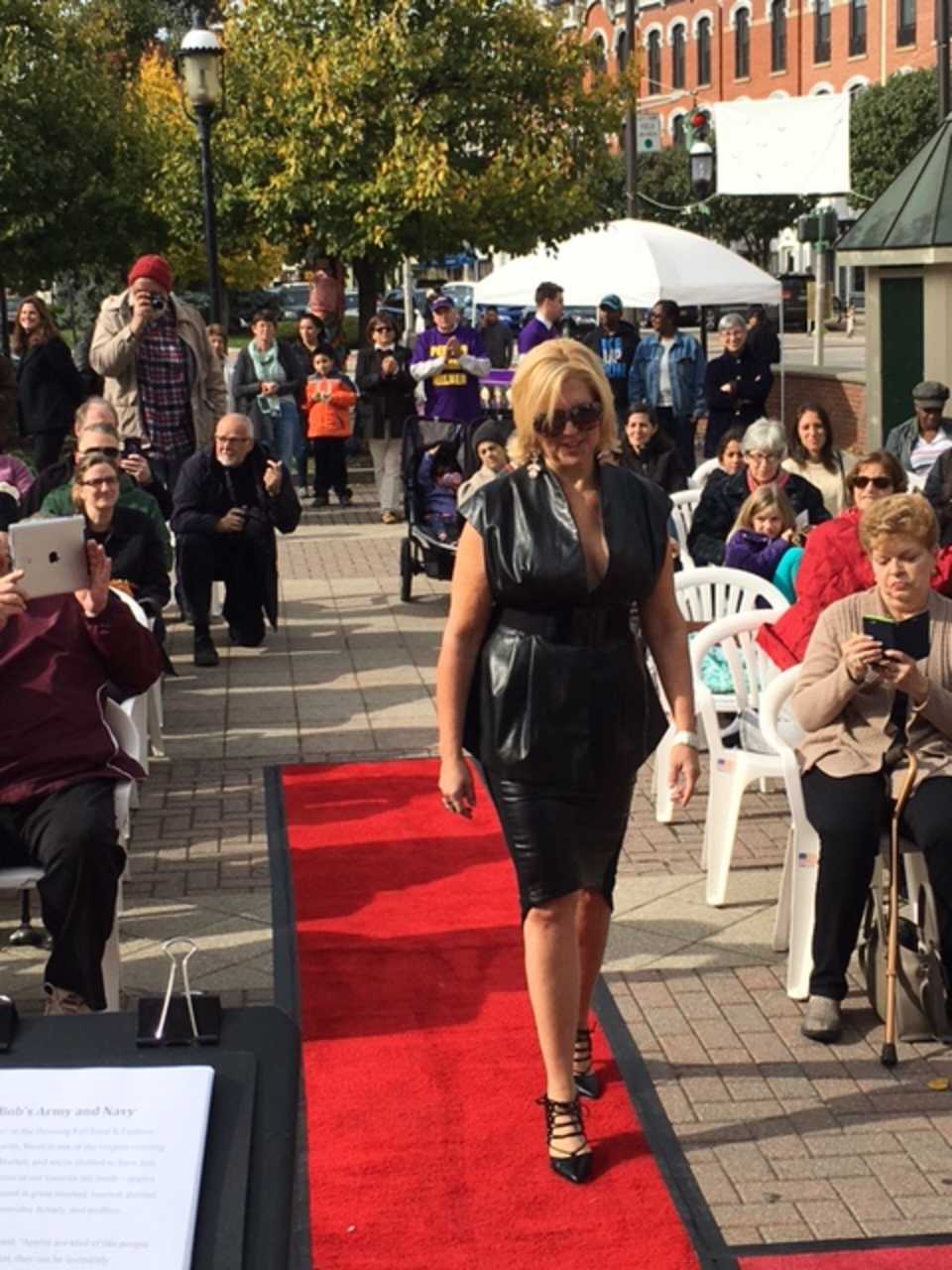 An Ossining resident makes her way down the red-carpet runway during the Fall Food and Fashion Show at Market Square on Saturday.