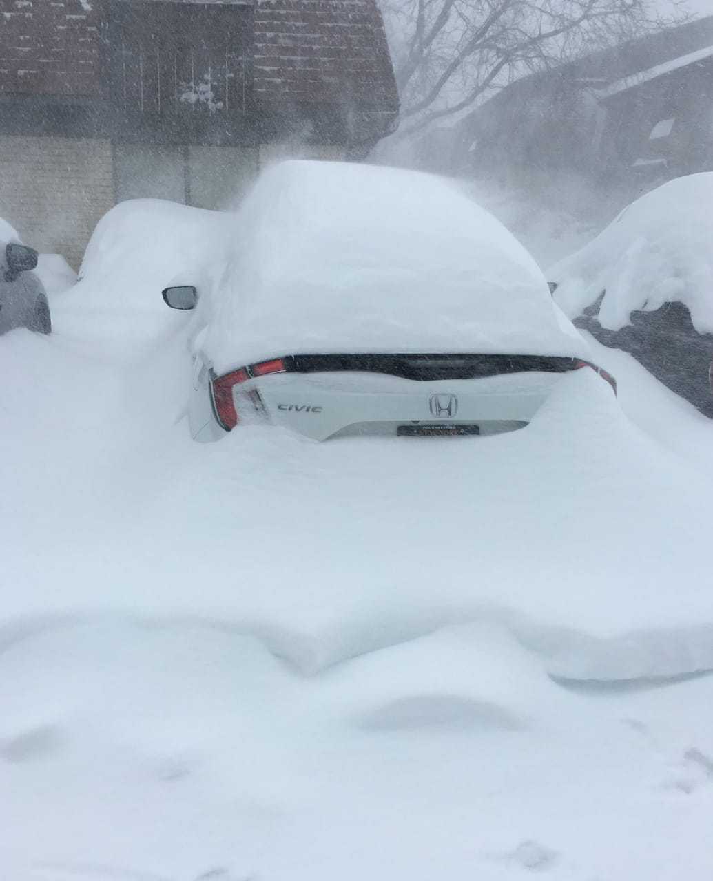 Cars are already buried in Poughkeepsie in a photo taken at noontime.