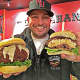 Dan DeMiglio holds the gouda mac and cheese truffle burgers sold exclusively at Callahan's in Norwood.