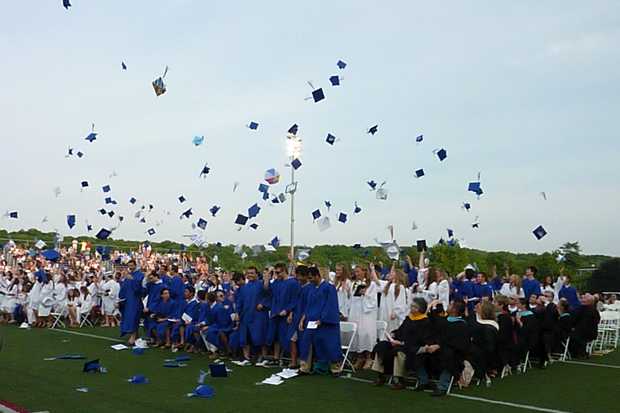 Members of Wilton High School's Class of 2013 throw their caps into the air at the close of Saturday's graduation ceremony.