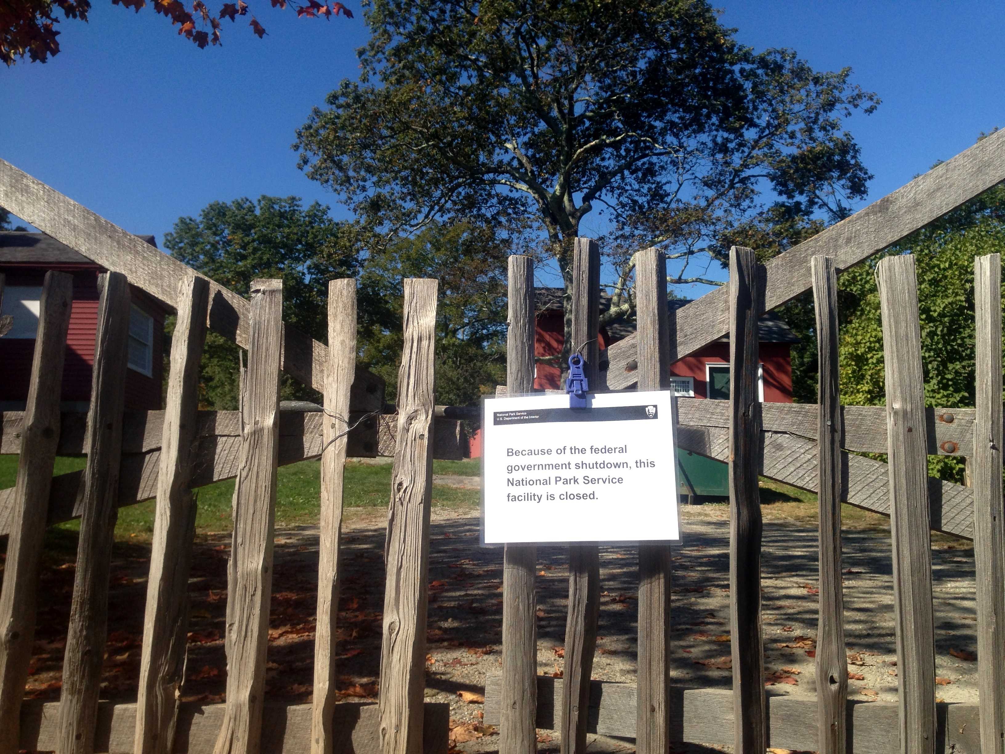 A closed sign is attached to the Adirondack-style picket fence near the J. Alden Weir house. 