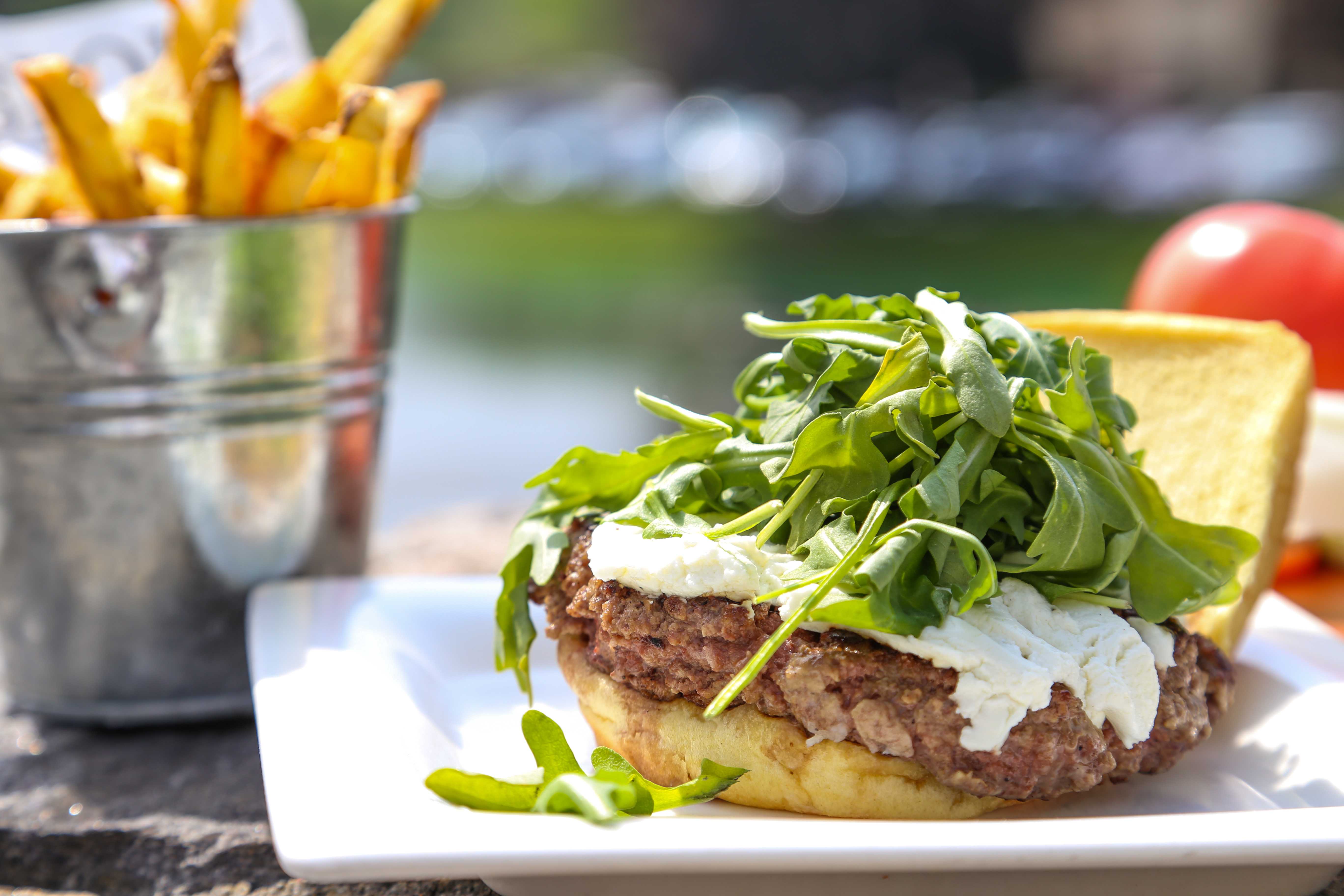 The G.O.A.T, or "Greatest of All Time," burger - which is a half-pound of Angus beef on a potato bun, served with melted goat cheese and arugula with a side of french fries ($15).