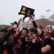 New Canaan players celebrate after beating Darien on Saturday in the Class L football state championship game.
