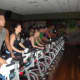 Members participate in a demonstration of the spin classes offered at Life Time Fitness.