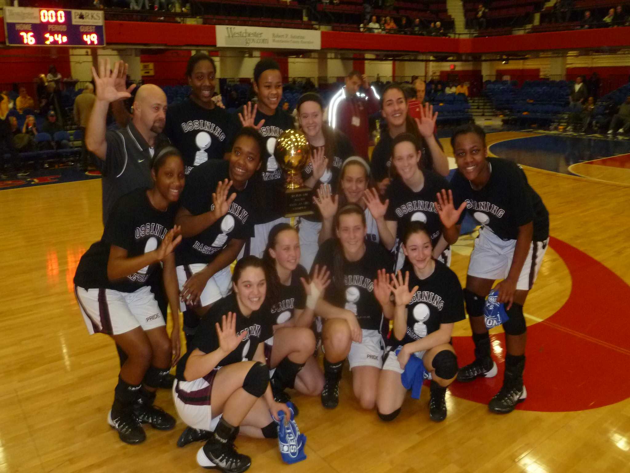 The Section 1 Class AA girls champion Ossining girls basketball yeam at center court at the County Center