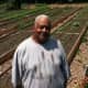Fairgate Farm Manager Bill Callion with vegetables growing behind him at Fairgate Farm. Located at 129-143 Stillwater Ave., it is having a free public event called "It Isn't Easy Being Green," Saturday from noon until 2 p.m.