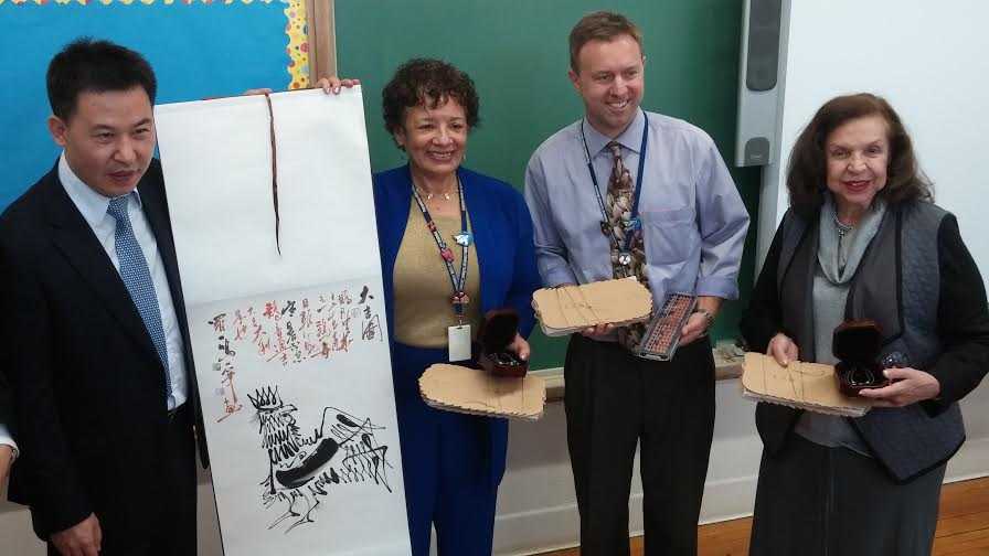 Pocantico Hills Superintendent  Valencia Douglas receives a painted banner from Chinese educators who visited the school.
