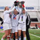 Somers players hoist the state-title trophy. 