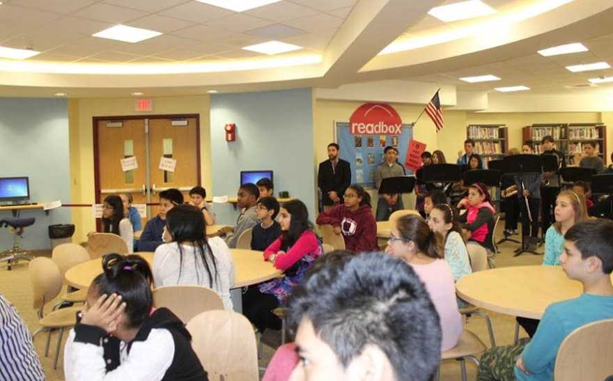Students listen to a presentation given about the library. 