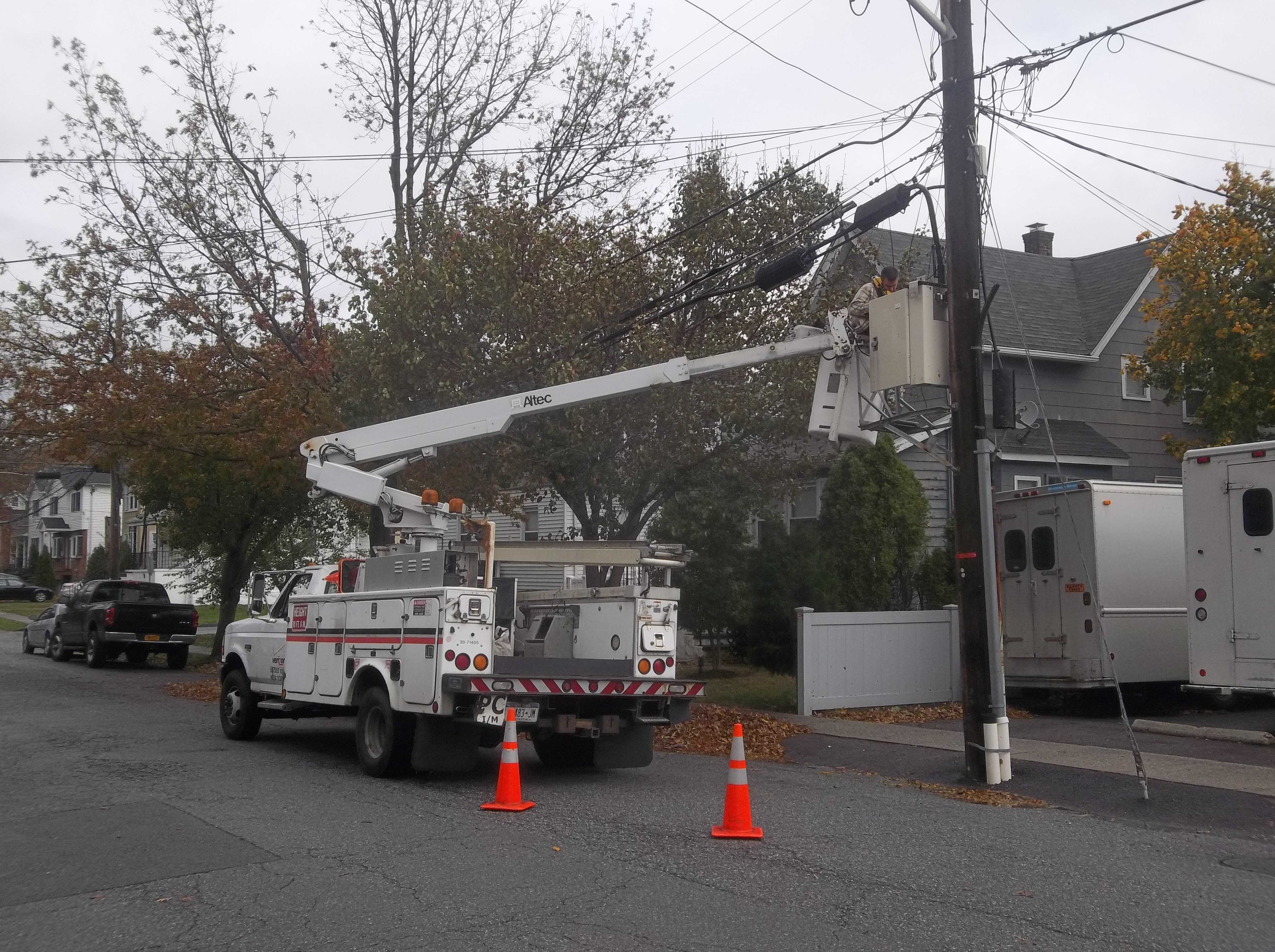 Con Edison workers are busy at work fixing power lines.