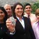 New Officer Kelly Coughlin holds her New Canaan Police Department badge, joined by his mother Laura, father Tim, brother TJ and grandmother Joan.