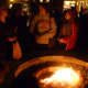 The new fire pit proved to be quite the attraction for visitors at Friday's New Canaan Holiday Stroll. 