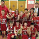 The fifth grade Somers boys basketball travel team poses with its trophy. 