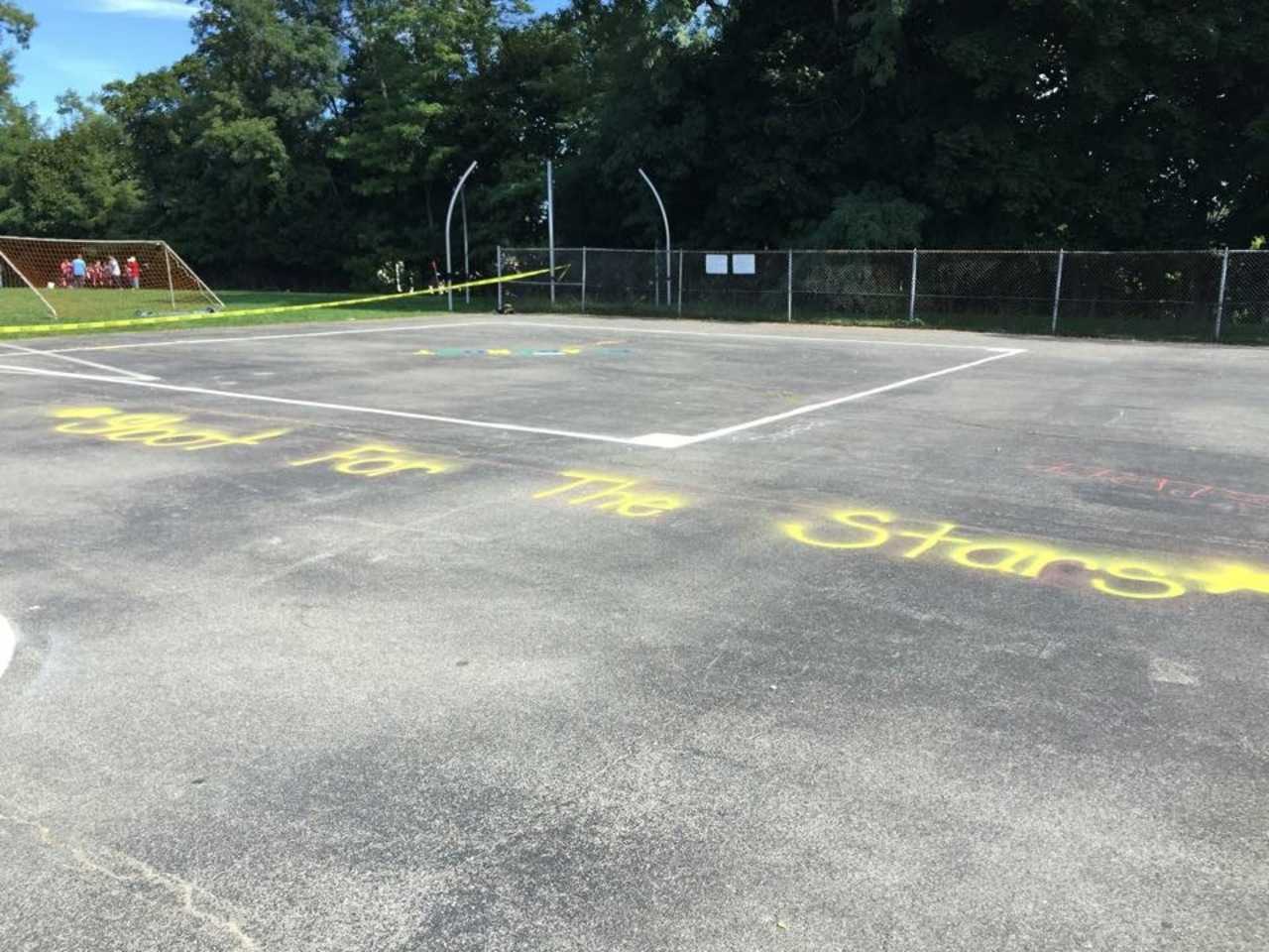 The Ossining Upper Elementary School PTA worked with parent volunteers and principal Kate Mathews to paint games and a basketball court at Claremont School. 