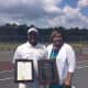 Marvin Tyler of Slammer Tennis World in Norwalk stands with the Mayor of Emporia, Va., Mary Person. The town recently honored Tyler for his contributions to the sport.