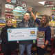 Ossining resident Leon Greenberg and his wife show off their $7 million Lottery winning.