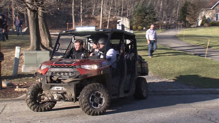 First responders drive an ATV to remove the body of a man found in a state park.