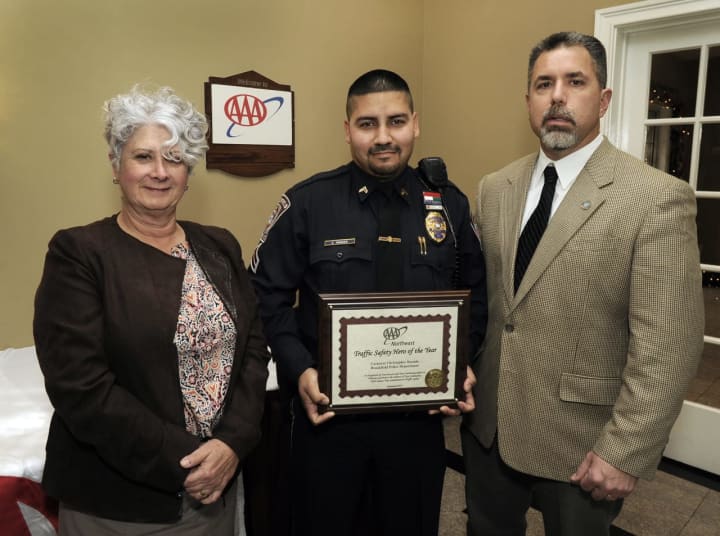 At AAA’s seventh annual Community Traffic Safety Awards lunch at Testo’s in Bridgeport, Public Affairs Manager Fran Mayko, left, presents Brookfield Police Cpl. Christopher Rosado with his award. At right is Brookfield Police Captain John Puglisi.