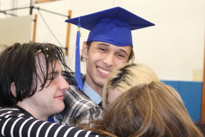 A BOCES graduate celebrates receiving his adult education diploma.