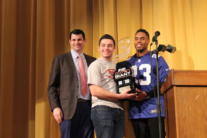 Mahopac High School senior Charlie Burt receives the Heart of a Giant award from Giants’ running back Rashad Jennings and Hospital for Special Surgery’s Dr. Sam Taylor.